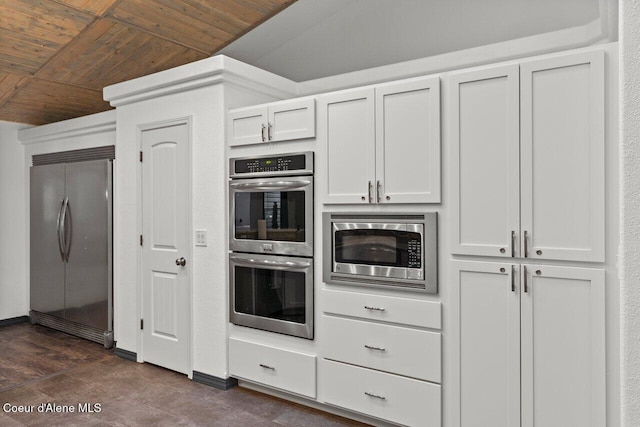 kitchen with wooden ceiling, white cabinets, stainless steel appliances, and vaulted ceiling