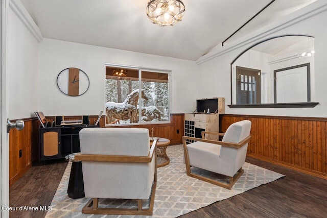 living area with wooden walls, dark hardwood / wood-style flooring, and vaulted ceiling