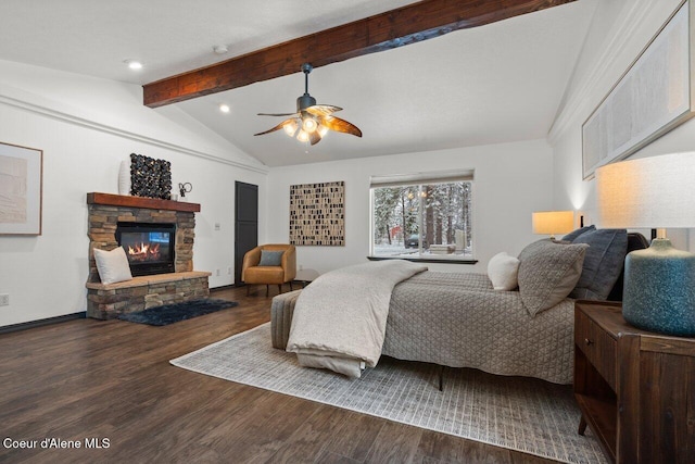 bedroom with vaulted ceiling with beams, ceiling fan, dark hardwood / wood-style floors, and a fireplace