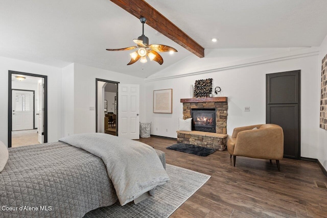 bedroom featuring ceiling fan, a fireplace, lofted ceiling with beams, and dark hardwood / wood-style floors