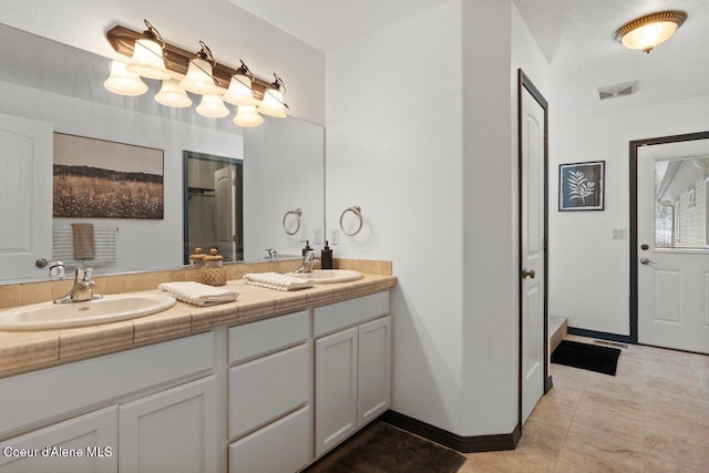 bathroom with tile patterned flooring and vanity