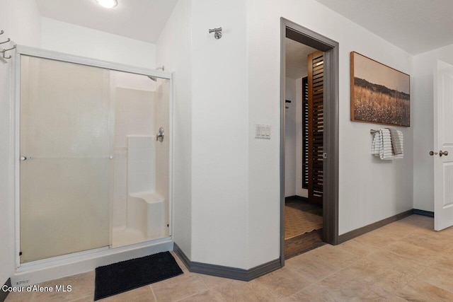 bathroom featuring a shower with shower door