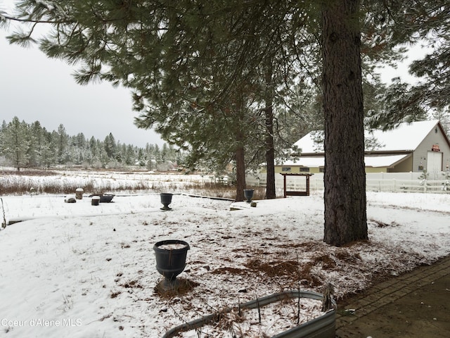 view of yard layered in snow