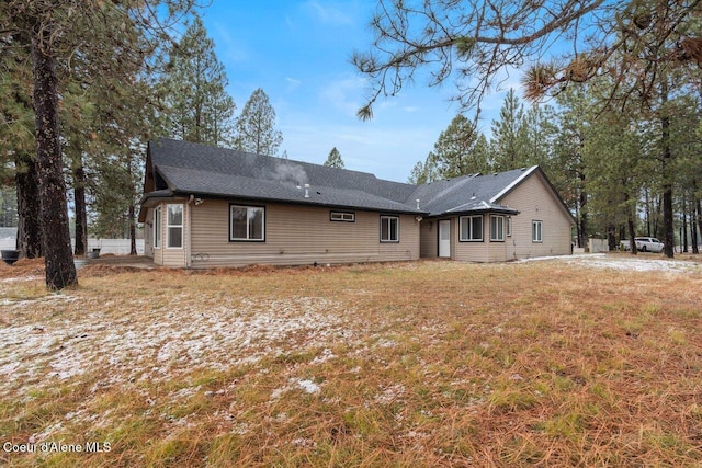 rear view of house featuring a lawn