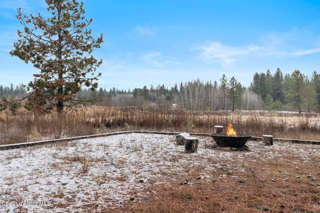 view of yard with an outdoor fire pit