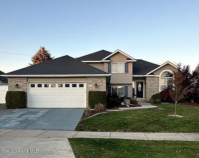 view of front of property featuring a garage and a front yard