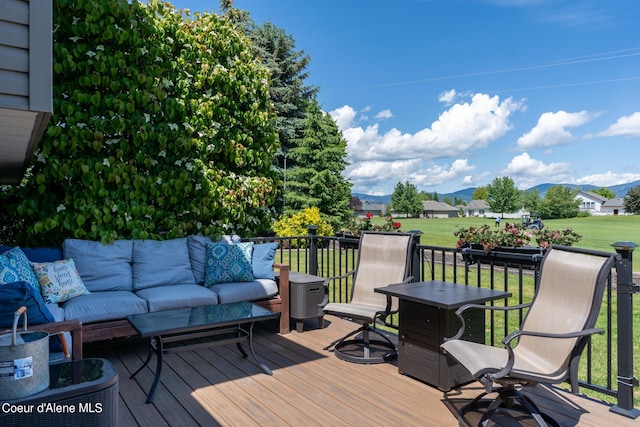 deck featuring outdoor lounge area and a lawn