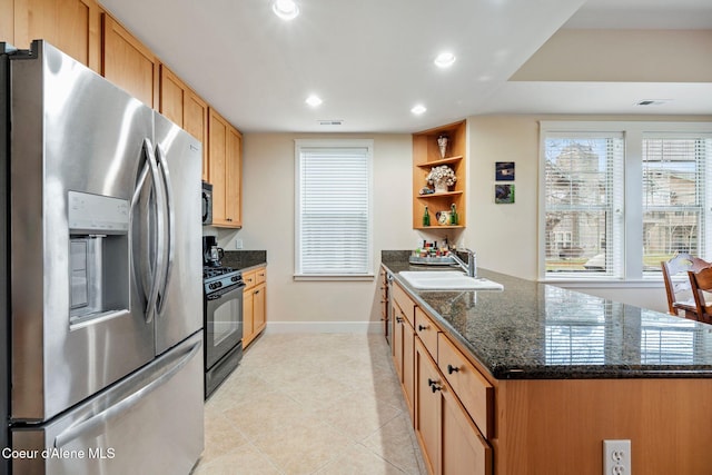 kitchen with black appliances, sink, dark stone countertops, light tile patterned floors, and kitchen peninsula