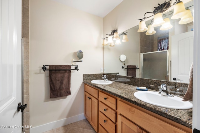 bathroom with tile patterned flooring, vanity, and walk in shower