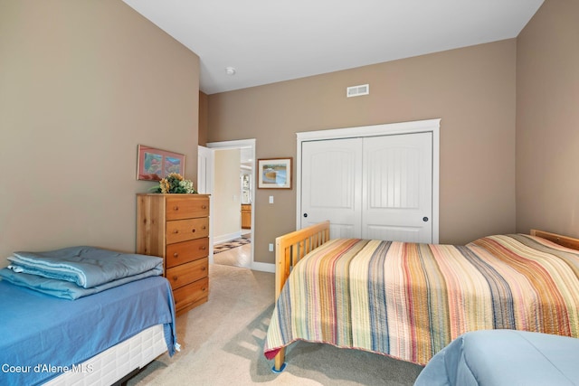 carpeted bedroom with a closet and lofted ceiling