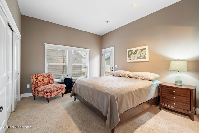 bedroom with light colored carpet and a closet