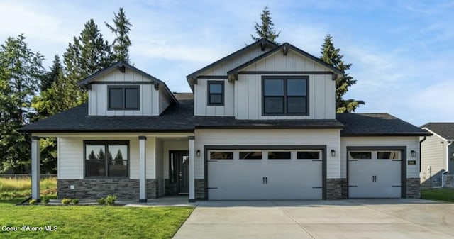 craftsman house with a garage, a front yard, and covered porch