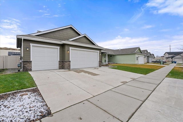 view of front of home featuring a front yard and a garage