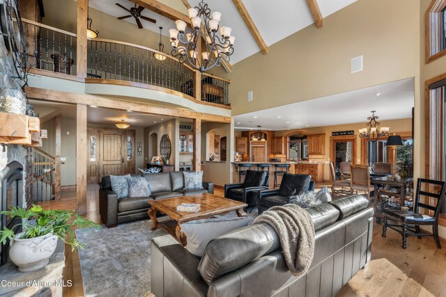 13277 S Ridgeview Loop, Harrison, ID 83833 - living area with a chandelier, high vaulted ceiling, light wood finished floors, beamed ceiling, and arched walkways