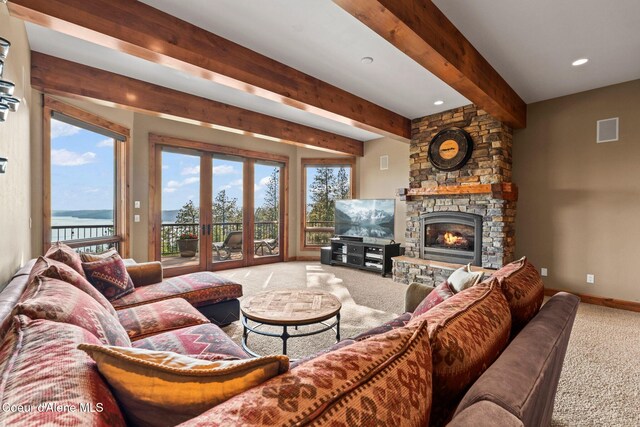 13277 S Ridgeview Loop, Harrison, ID 83833 - carpeted living area featuring beamed ceiling, a stone fireplace, a water view, and recessed lighting