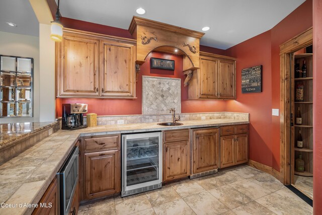 13277 S Ridgeview Loop, Harrison, ID 83833 - kitchen featuring beverage cooler, brown cabinets, recessed lighting, and decorative backsplash