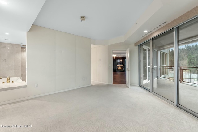 unfurnished room featuring light carpet