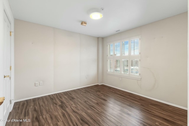 empty room with dark hardwood / wood-style floors