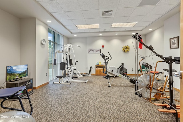 gym featuring carpet and a paneled ceiling