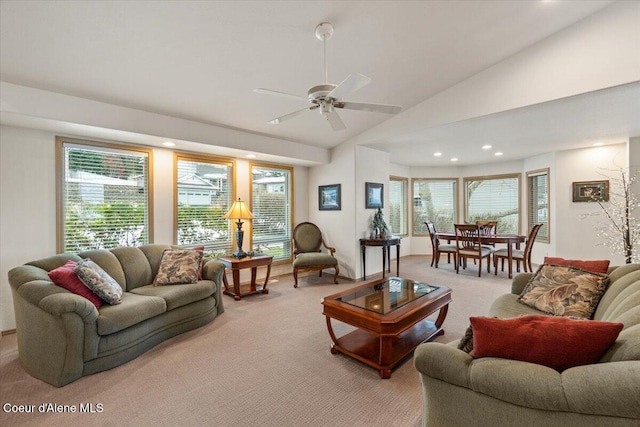 living room with light carpet, vaulted ceiling, and ceiling fan