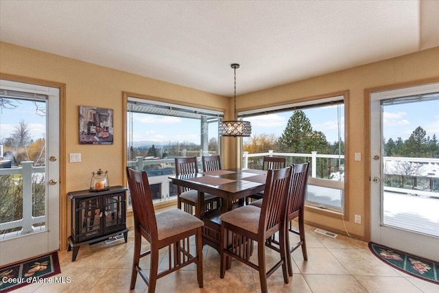 dining space featuring light tile patterned flooring