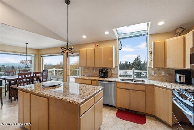 kitchen featuring a center island, hanging light fixtures, stainless steel appliances, backsplash, and vaulted ceiling with skylight