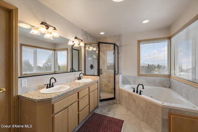 bathroom featuring plus walk in shower, vanity, and tile patterned floors