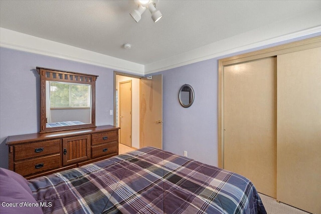 carpeted bedroom featuring a closet