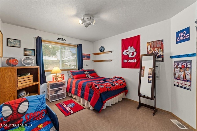 carpeted bedroom with a textured ceiling