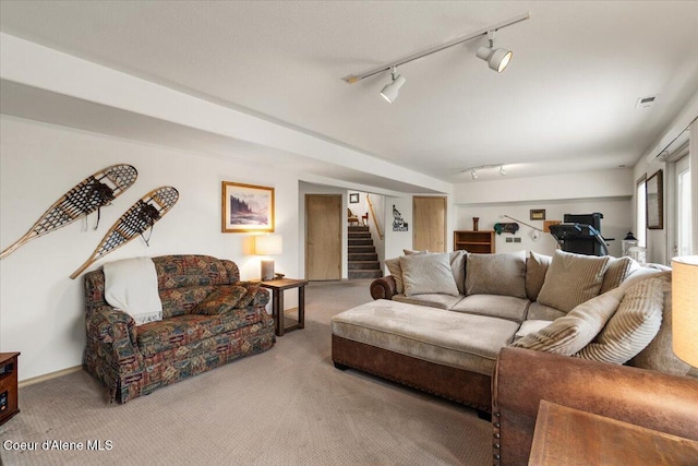 carpeted living room featuring track lighting