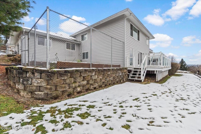 view of snow covered exterior featuring a wooden deck