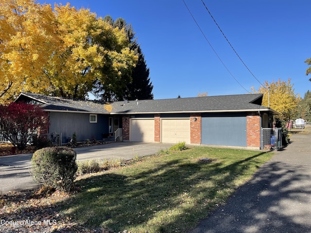 single story home with a front yard and a garage