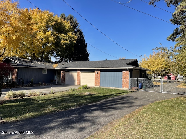 view of front of property featuring a garage and a front yard