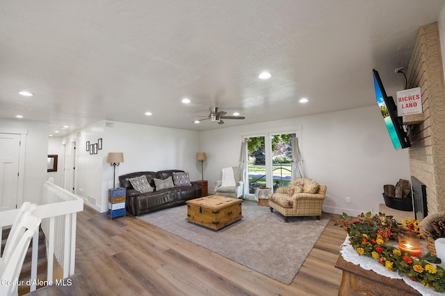 living room featuring hardwood / wood-style flooring and ceiling fan