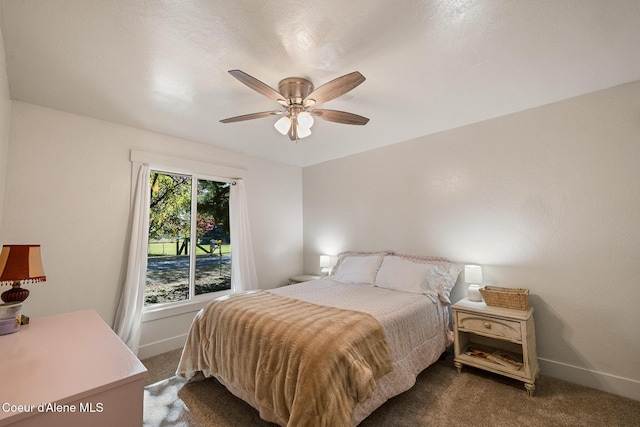 bedroom featuring ceiling fan and dark carpet