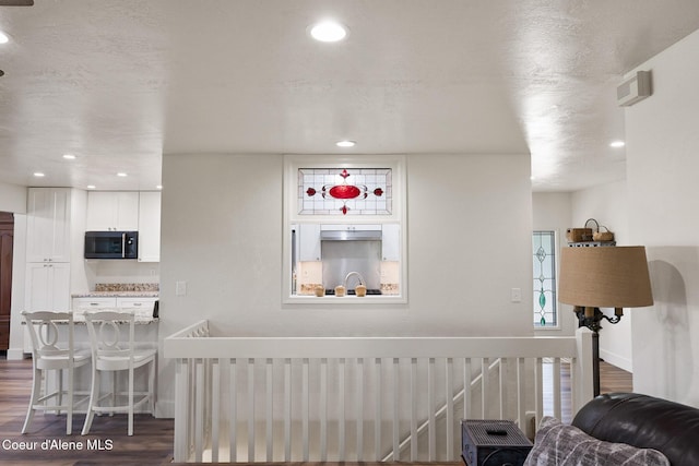 interior space featuring hardwood / wood-style flooring and a textured ceiling