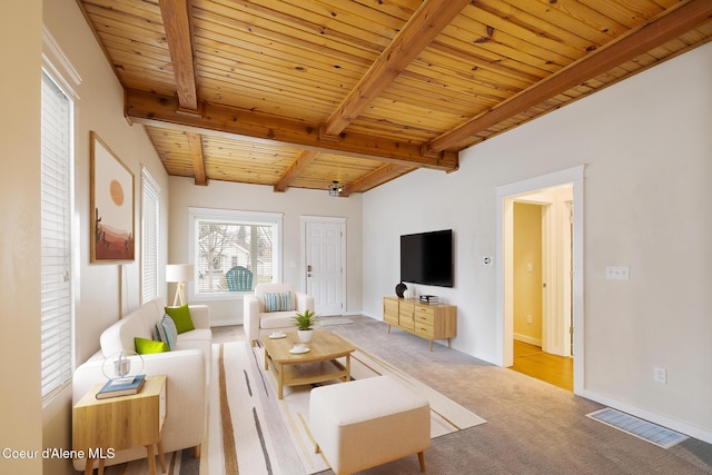 living room featuring beam ceiling, light colored carpet, and wooden ceiling