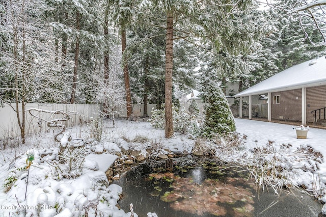 view of yard layered in snow