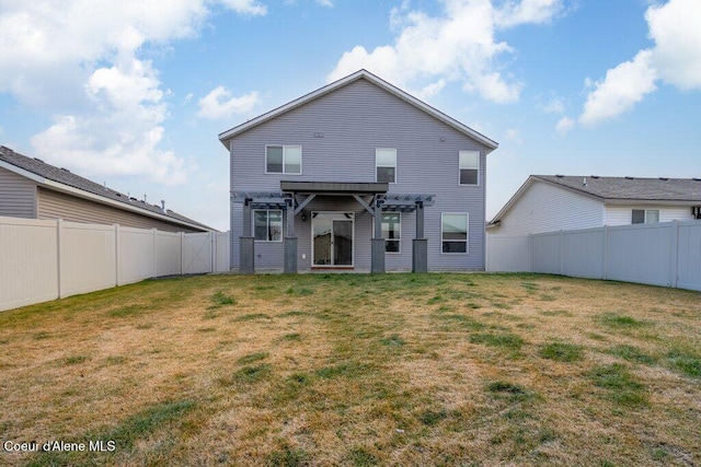 rear view of property with a pergola and a lawn