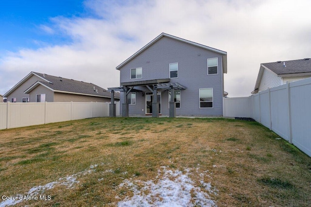 rear view of property featuring a pergola and a yard