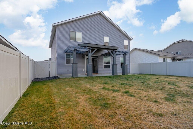 back of property featuring a pergola and a yard