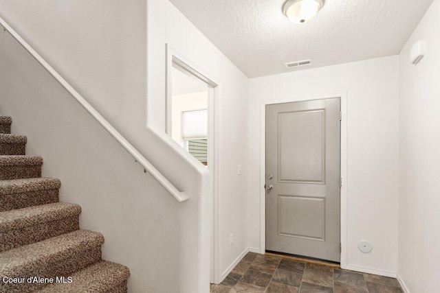 foyer with a textured ceiling