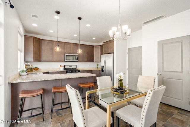 dining space featuring sink and a chandelier