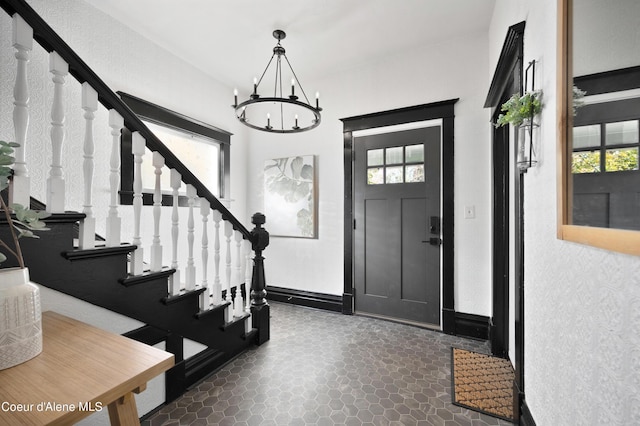 entrance foyer featuring a notable chandelier and a healthy amount of sunlight