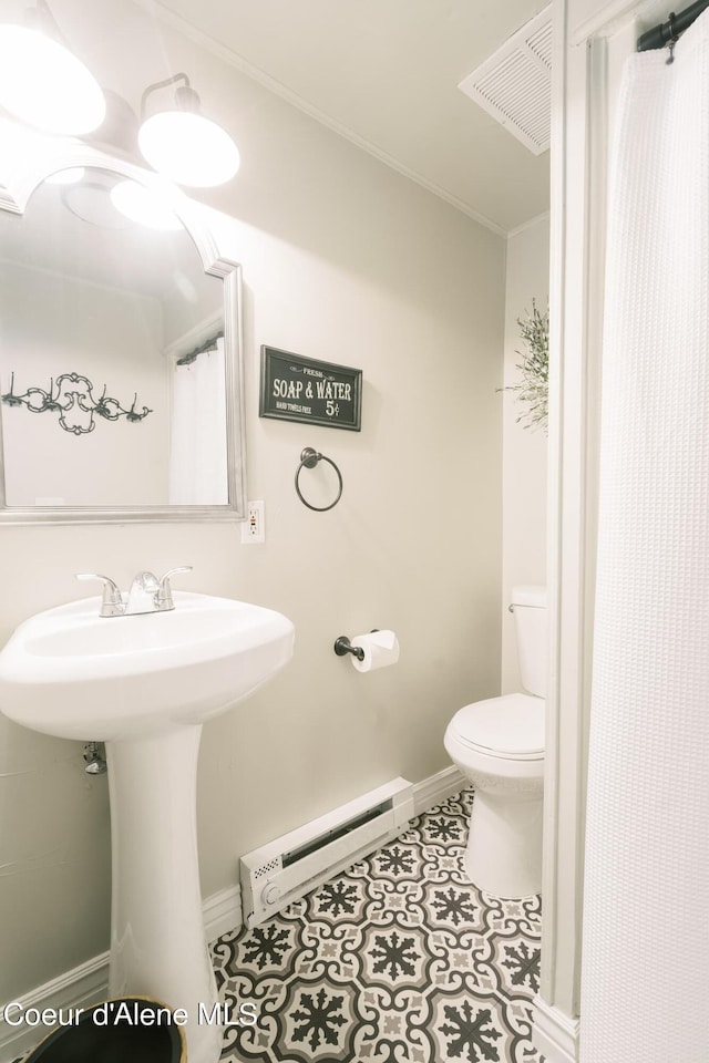 bathroom with toilet, tile patterned flooring, and a baseboard radiator