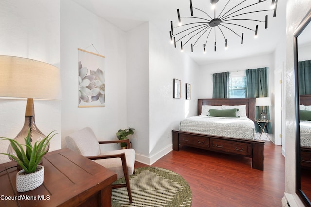 bedroom with dark wood-type flooring and a baseboard radiator