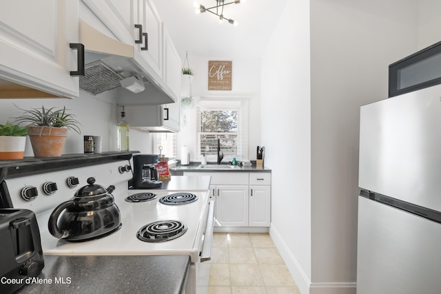 kitchen with electric range, refrigerator, white cabinets, light tile patterned flooring, and sink