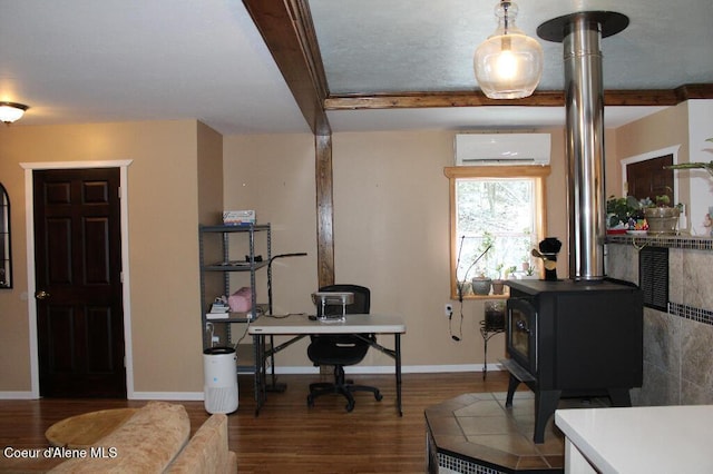 office area featuring baseboards, a wall mounted air conditioner, beamed ceiling, wood finished floors, and a wood stove