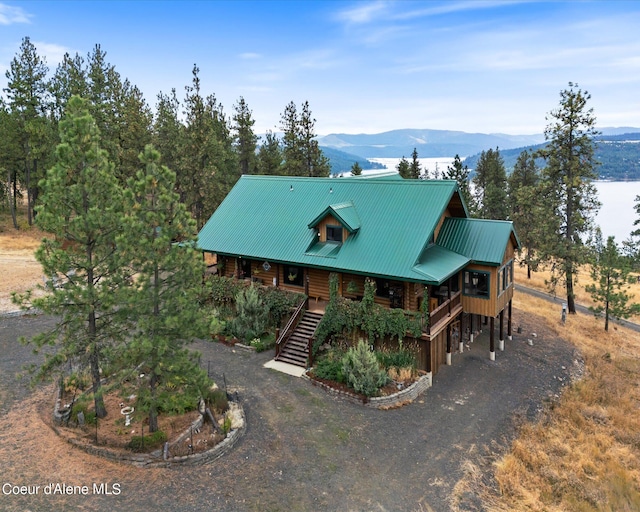 log home featuring a mountain view and covered porch