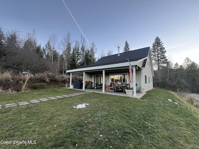 back of house featuring a yard and a patio